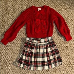 Holiday bow sweater and plaid pleated skirt